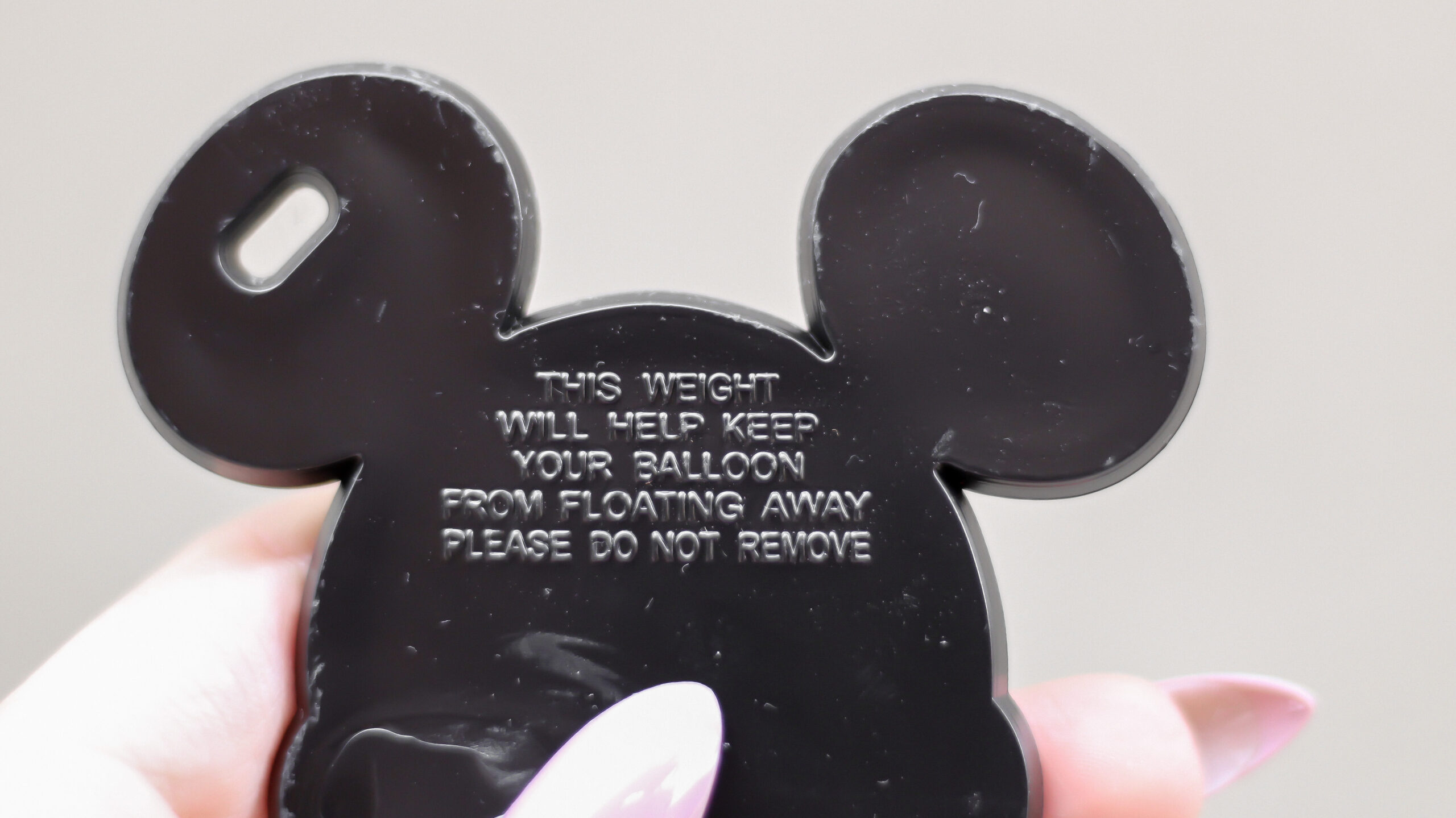 Back of old balloon weight at Walt Disney World