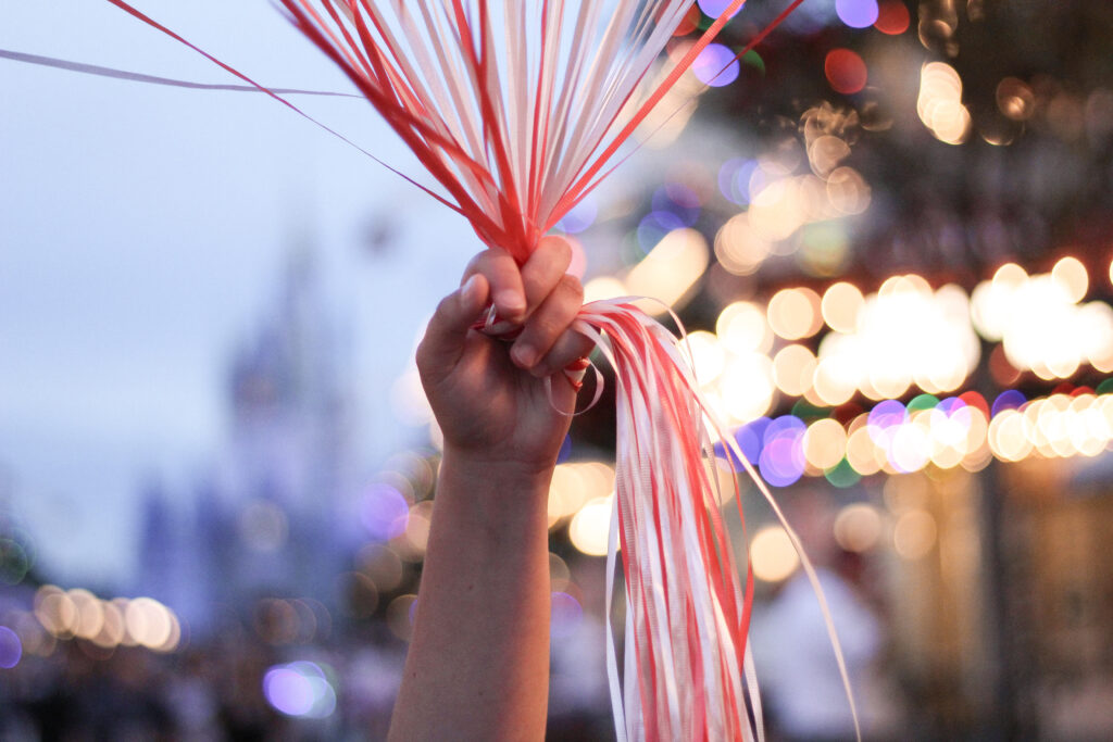 balloon vendor holding Christmas balloons on Main Street, U.S.A.