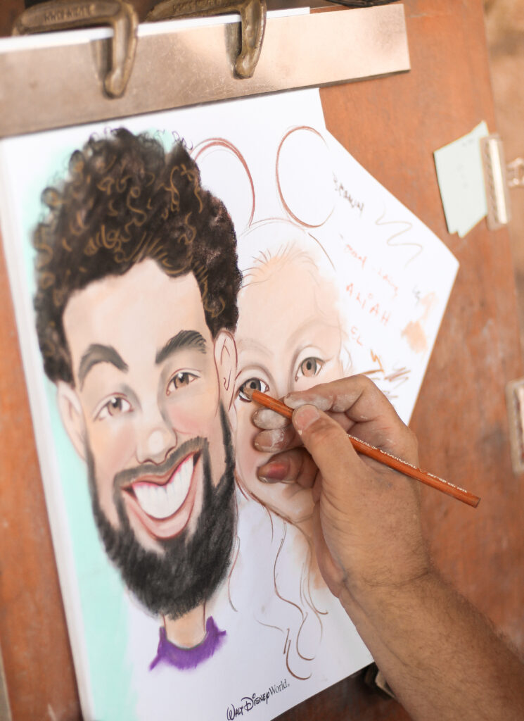 image of a caricature artist sketching, showing the differences between portraits & caricatures