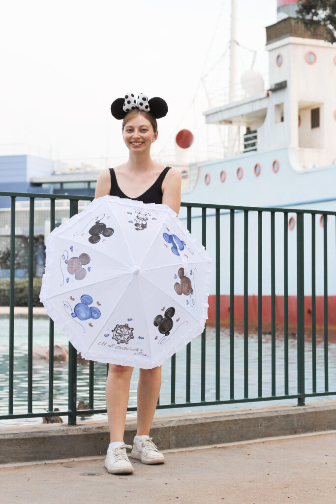 A guest with a custom Steamboat Willie inspired parasol at Disney's Hollywood Studios