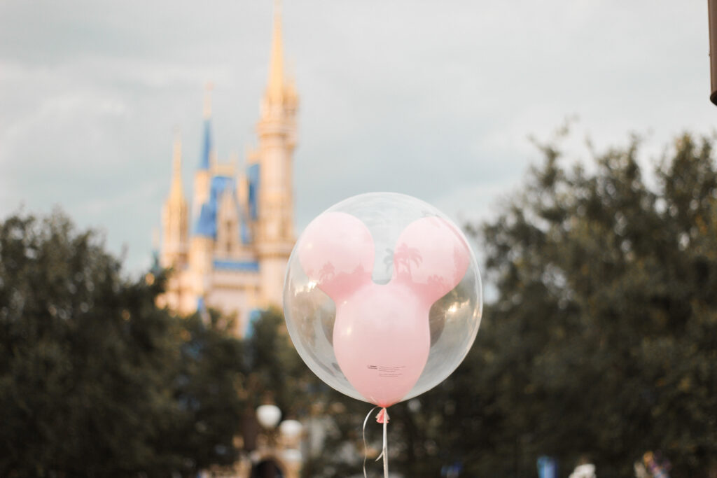 A pink Mickey Mouse balloon near Cinderella Castle at Walt Disney World