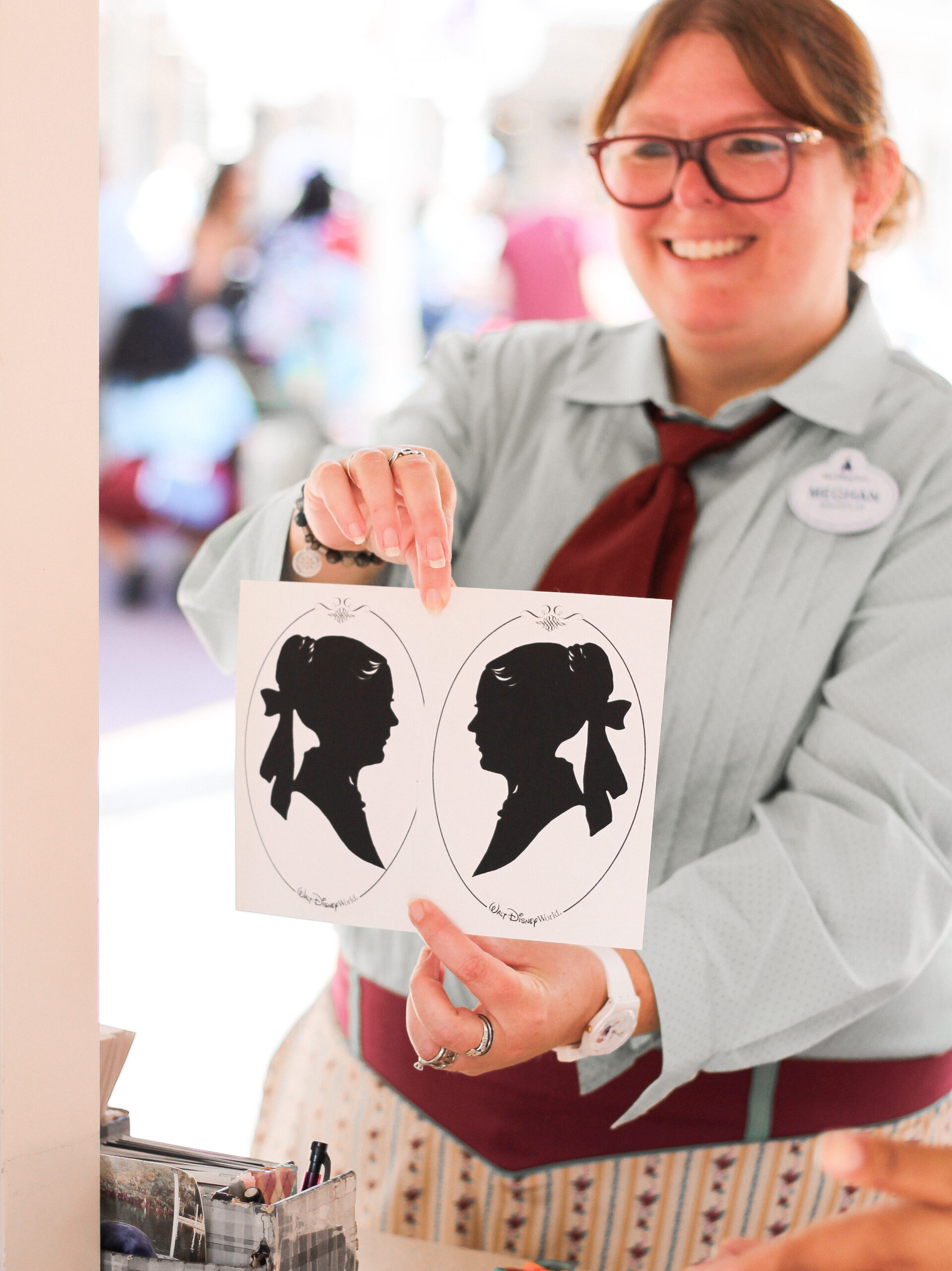 Silhouette artist Meghan with a recently completed silhouette at Magic Kingdom