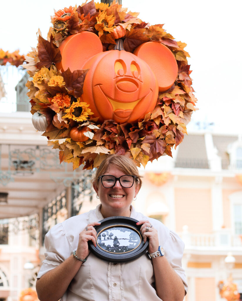 Silhouette artist Meghan with a recently completed Halloween silhouette at Magic Kingdom